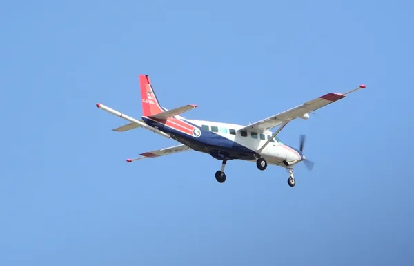 Single-engine fixed-wing aircraft used for airborne geophysical survey, with a magnetic sensor boom extending behind the fuselage